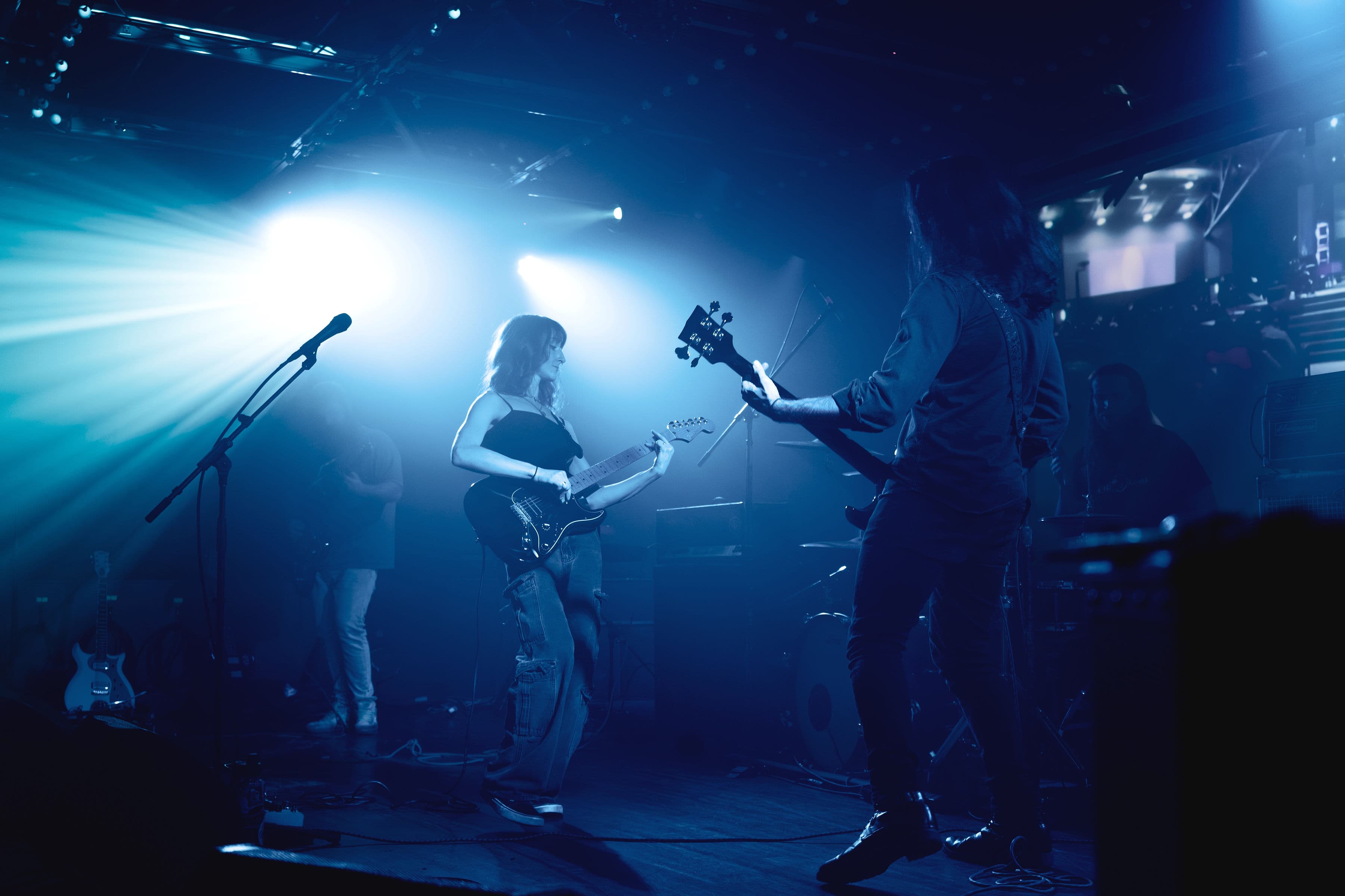 No Culture performing live in Birmingham, Alabama, bathed in blue stage light